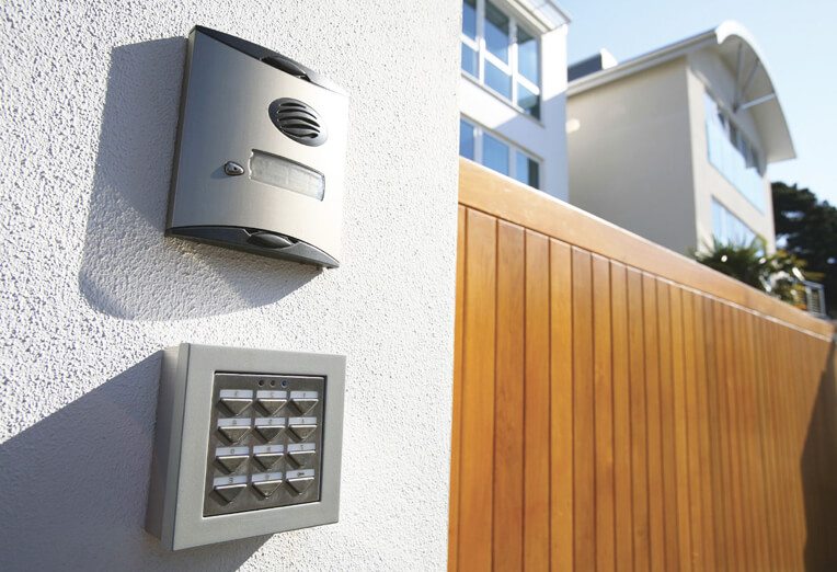 Residential access control system with intercom and keypad installed at a modern home entrance