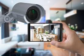 A high-definition indoor security camera installed in a modern living room, streaming live footage to a smartphone for real-time home monitoring and safety.