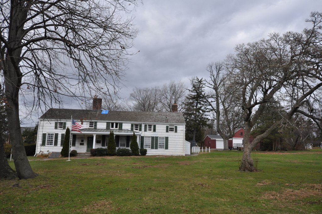 Historic white Bush-Lyon Homestead and grounds in Port Chester